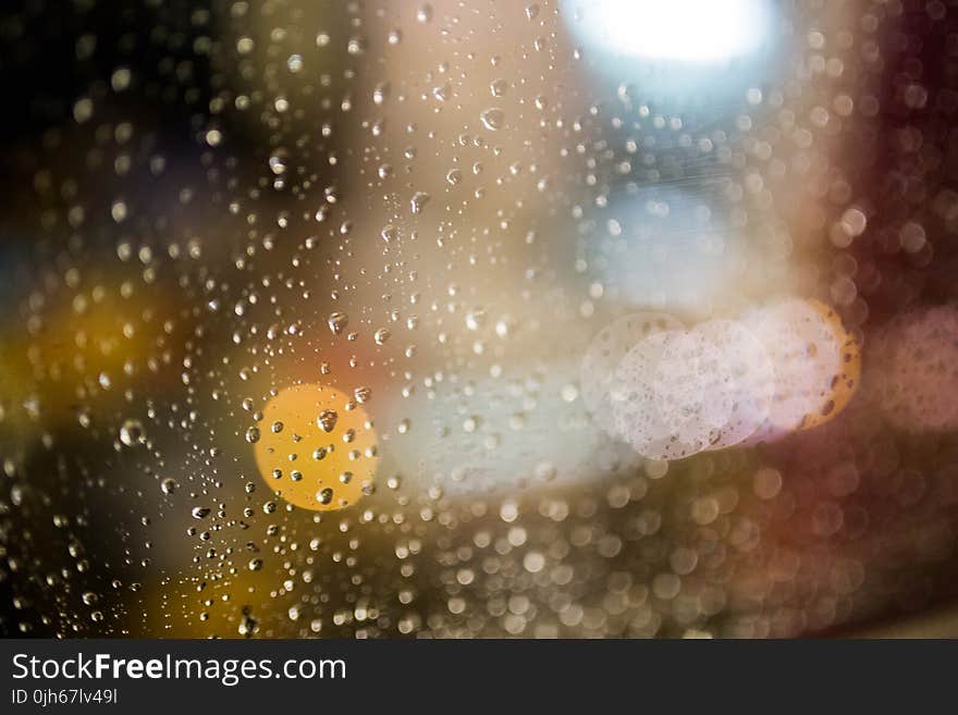 Water Drops on Clear Glass during Nightime