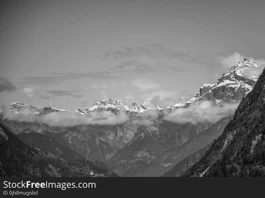 Snow Covered Rugged Mountain With Mist Photograph