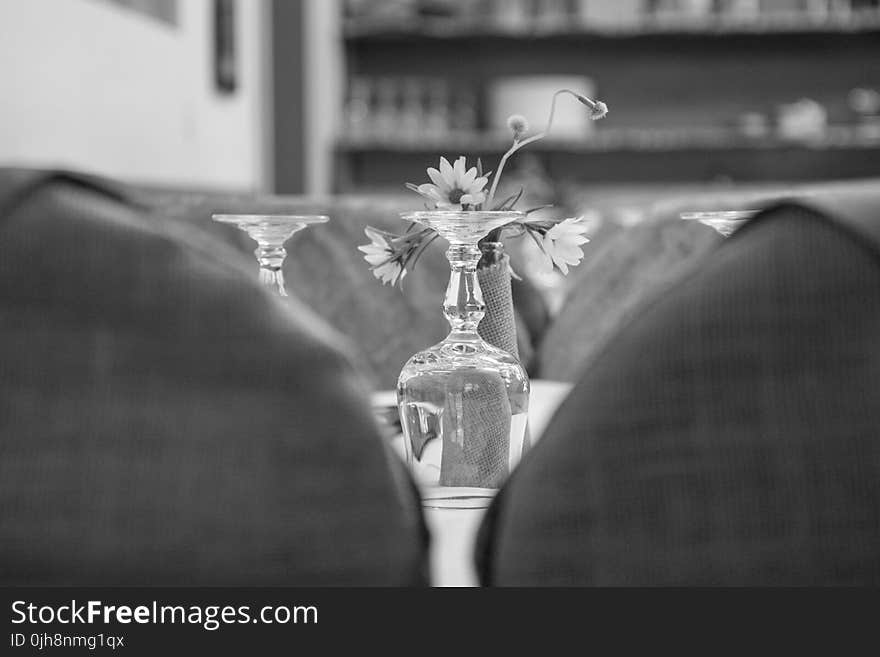 Upside Down Wine Glass Behind the Flower Grayscale Photo