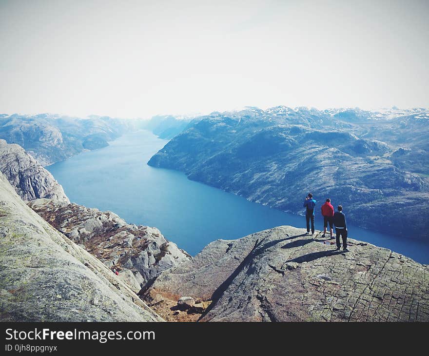 People on Top of Mountain Range