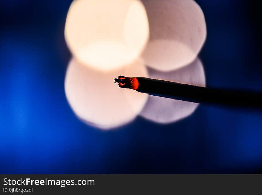 Lighted Cigarette Stick With Bokeh Photography