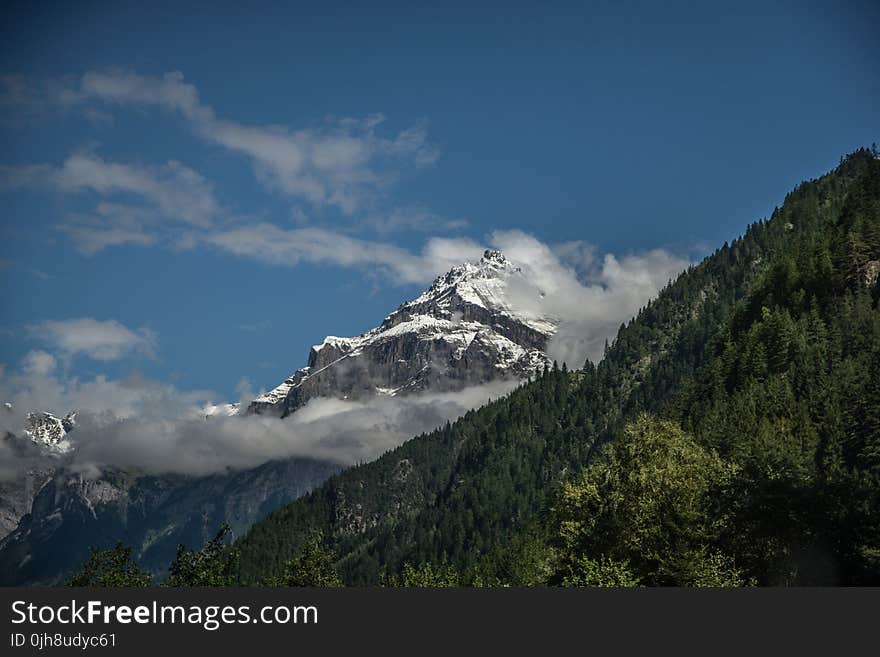 White and Green Mountain Under White Clouds