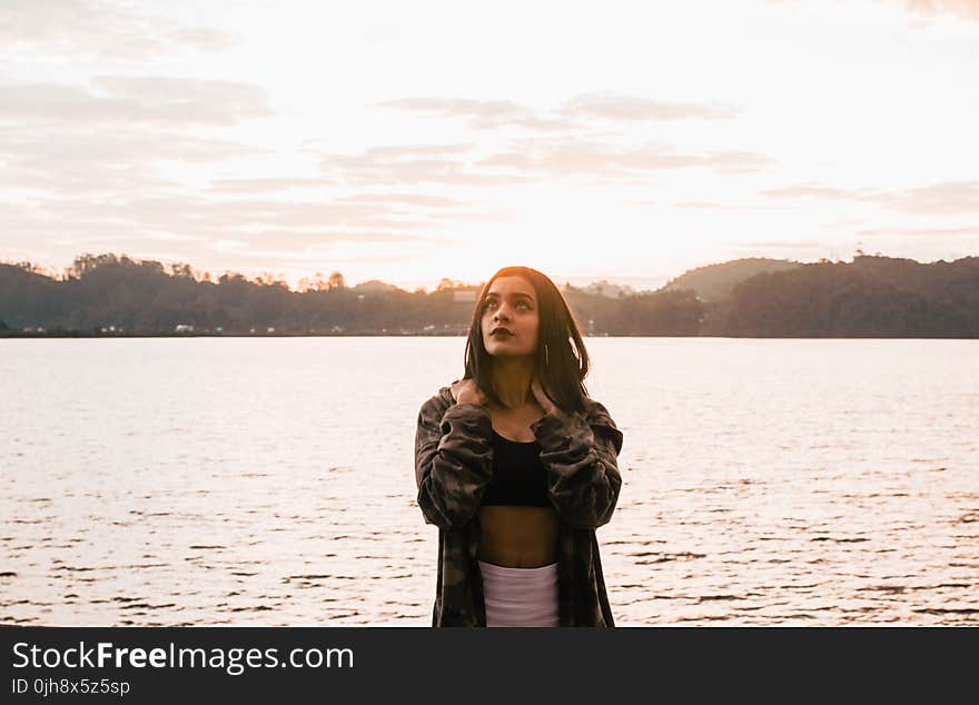 Woman Wearing Jacket Standing Near The Ocean