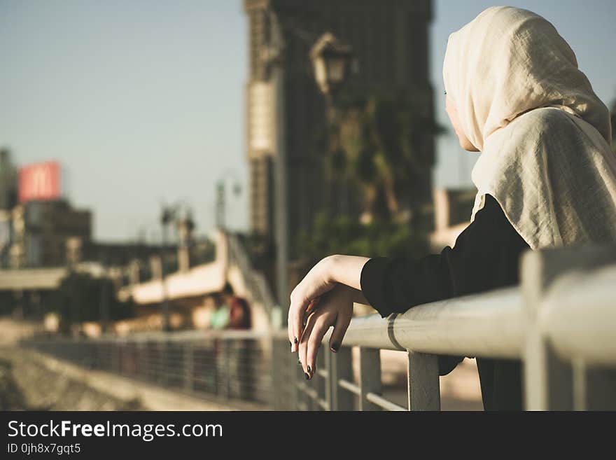 Woman Leaning on Hand Rails