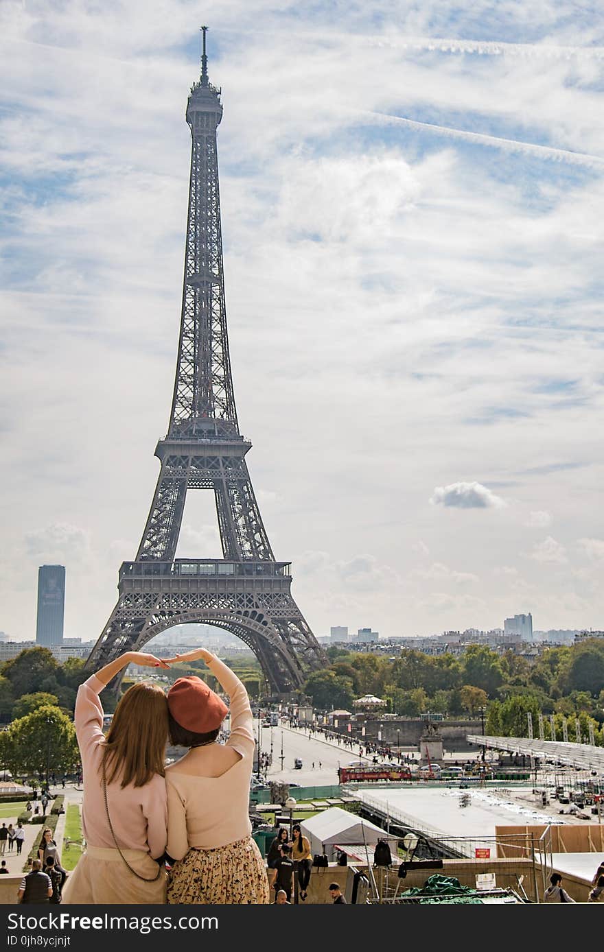 Photo of Two Women Posing in Front of Eiffel Tower, Paris, France during Day Time