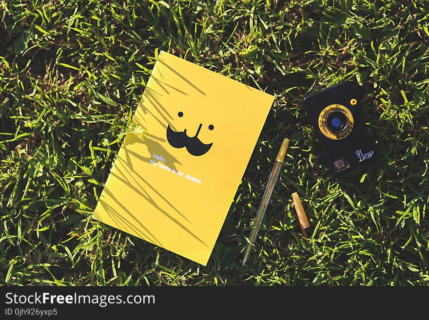 Yellow notebook on the grass