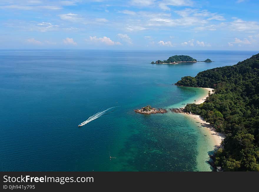 Aerial View of White Boat Traveling Near Green Island