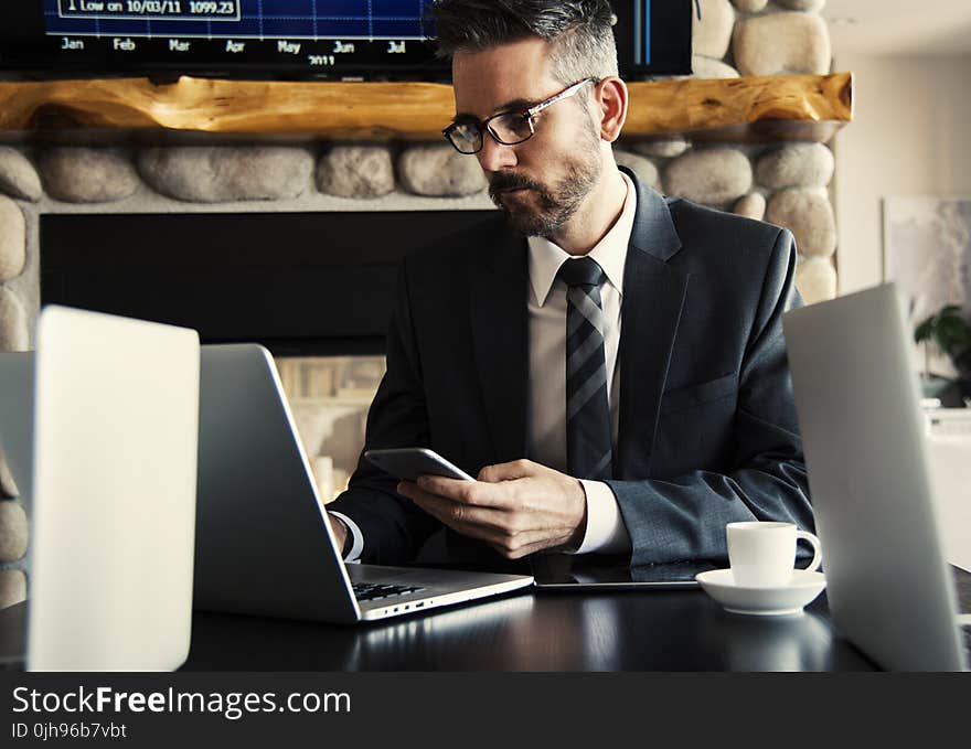 Man in Black Holding Phone