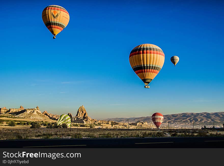 Four Beige Hot Air Balloons Flying