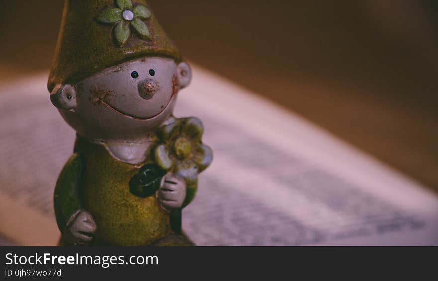 Closeup Photo of Boy Holding Flower Figurine