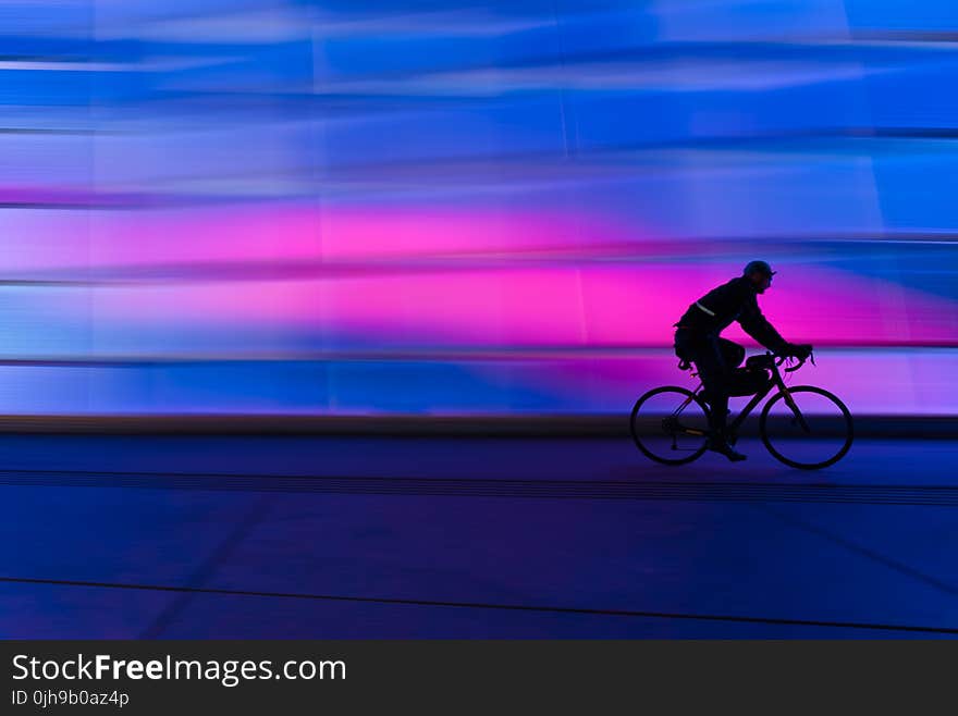 Silhouette of Person Riding on Commuter Bike