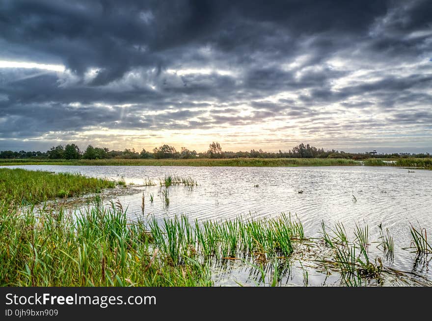 Photo of Body of Water Under Black Clouds