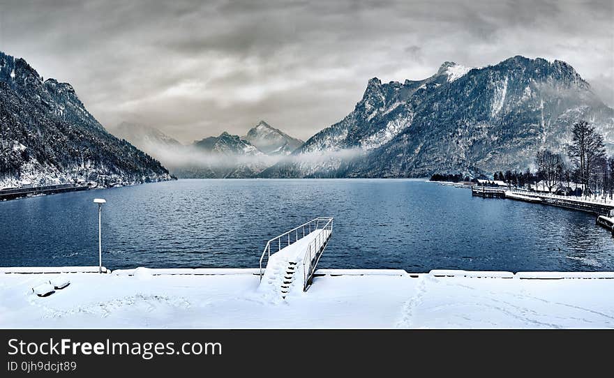 Dock Covered With Snow Near Lake