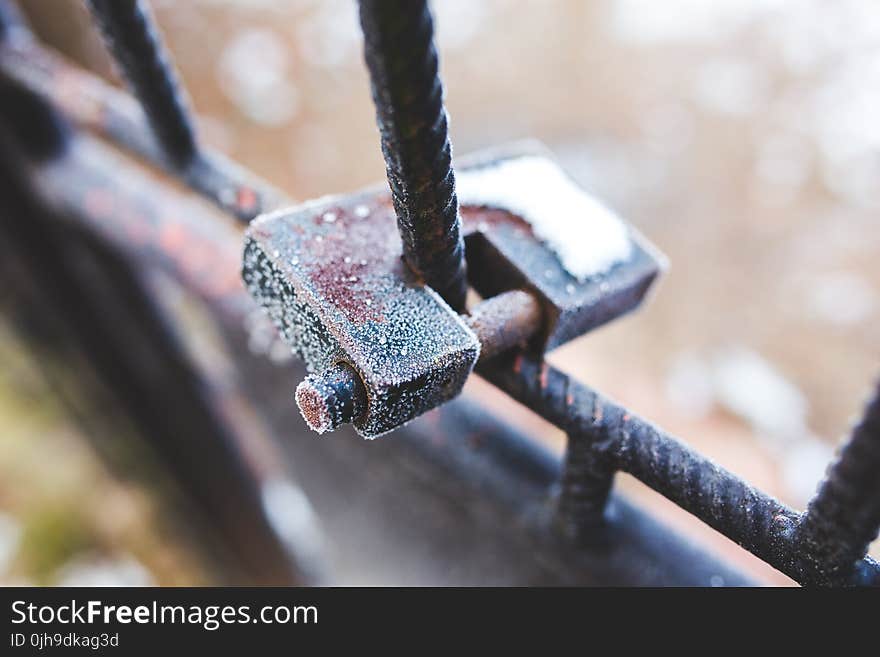 Rusty padlock covered with hoarfrost ice crystals