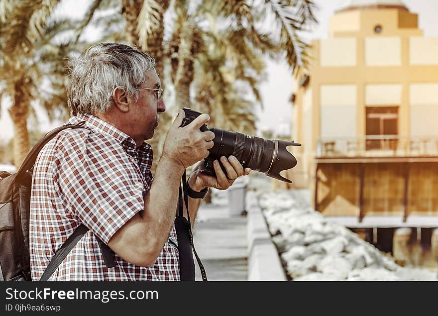 Man Holding Dslr Camera