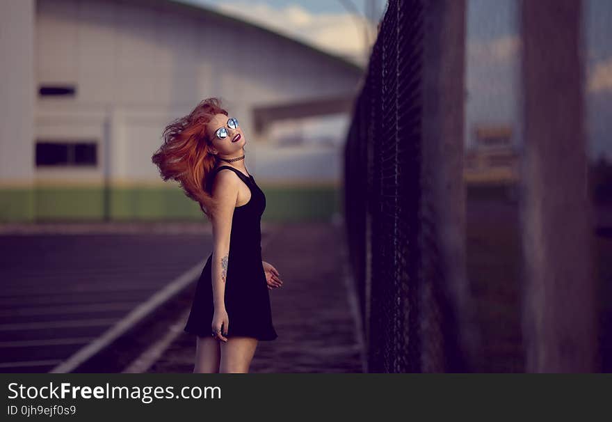 Shallow Focus Photo of Woman in Black Dress