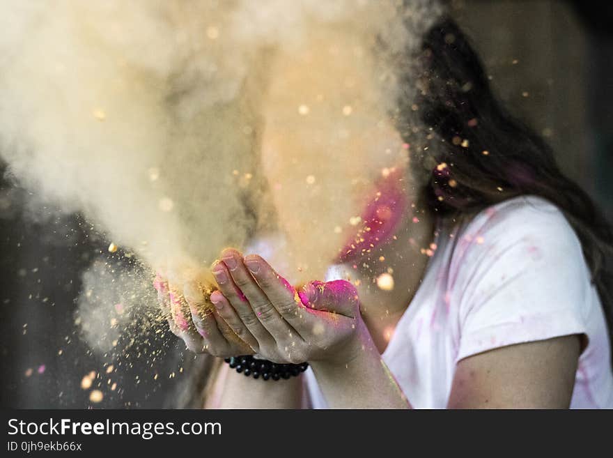 Woman in White Cap-sleeved Shirt Blowing Dust
