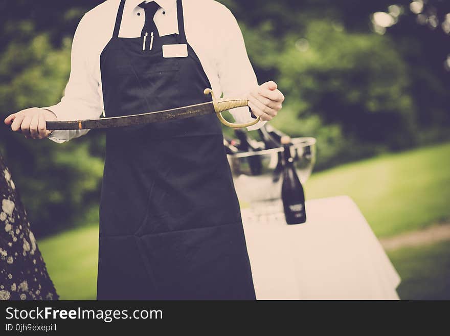 Man Wearing Apron Holding Sword