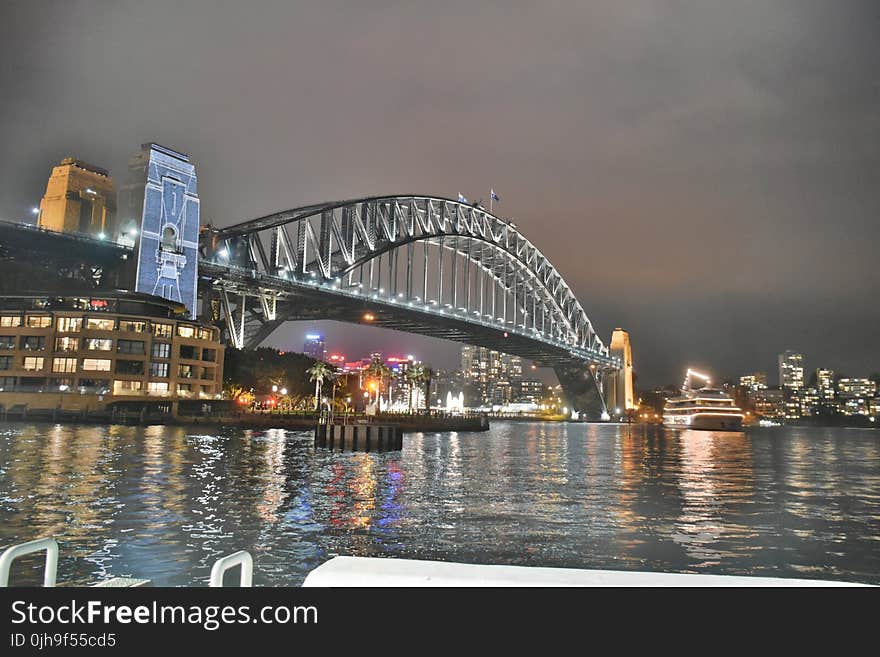 Bridge Under Grey Cloudy Sky During Nighttime