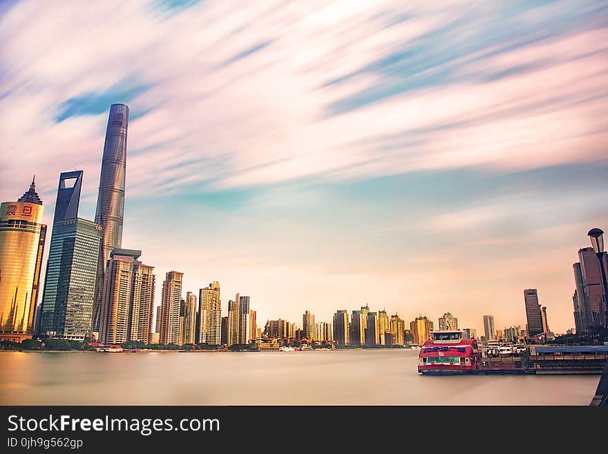 High-rise Buildings Near Body Of Water During Golden Hour