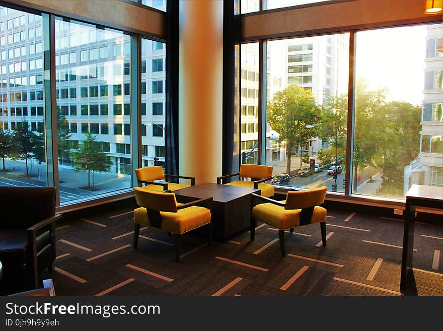 Brown Coffee Table Surrounded by Four Chairs