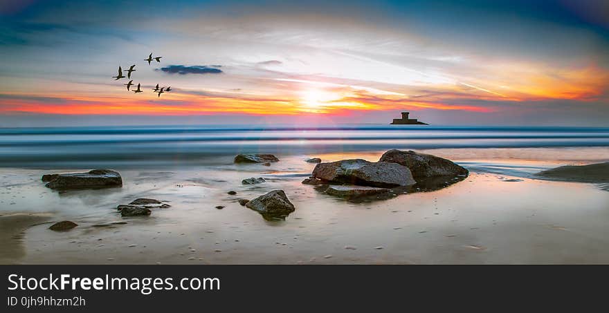 Sea Rocks Surrounded by Body of Water High-saturated Photography