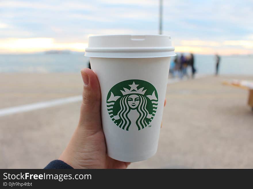 Person Holding Star Buck Plastic Cup