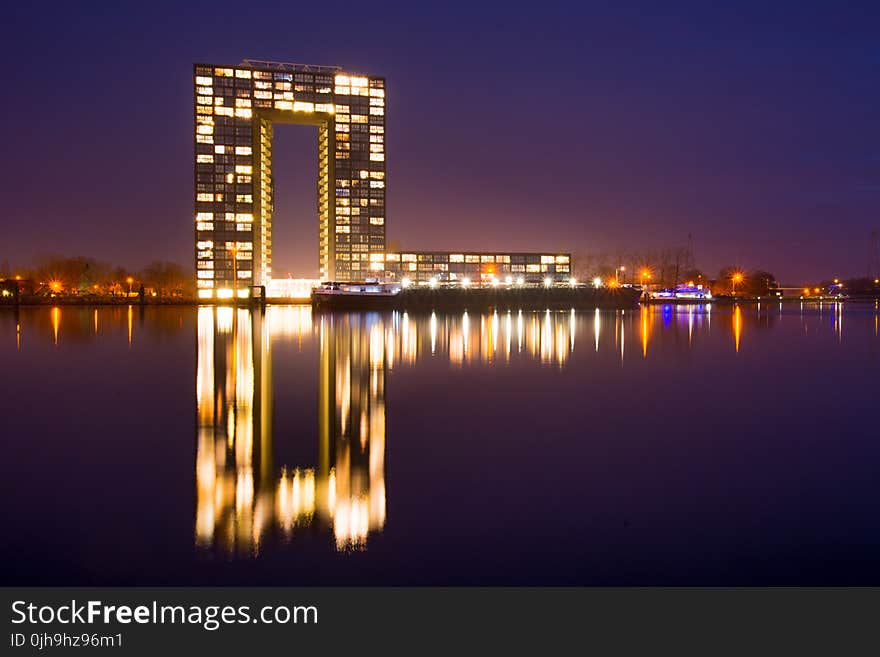 City Building Near Body of Water during Nighttime