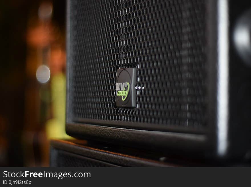 Black Speaker On Brown Wooden Stand