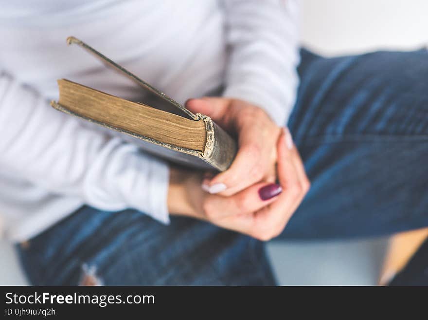 Girl holding an old closed book