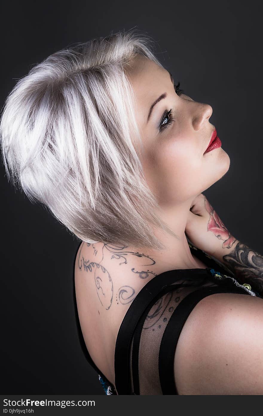 Woman Wearing Black Shirt With Tattoo and Red Lipstick