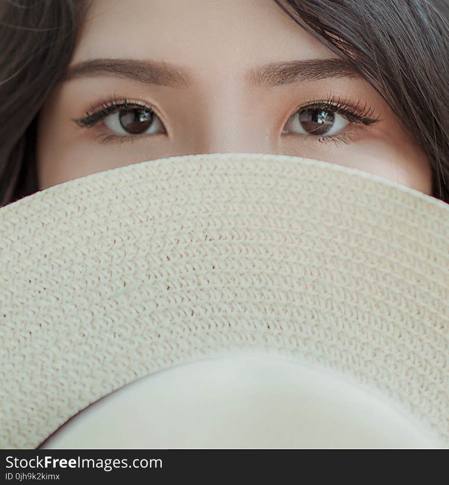 Person Covering Face With Hat Photo