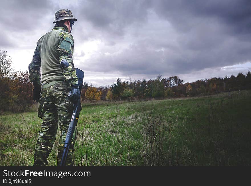 Man in Camouflage Soldier Suit While Holding Black Hunting Rifle