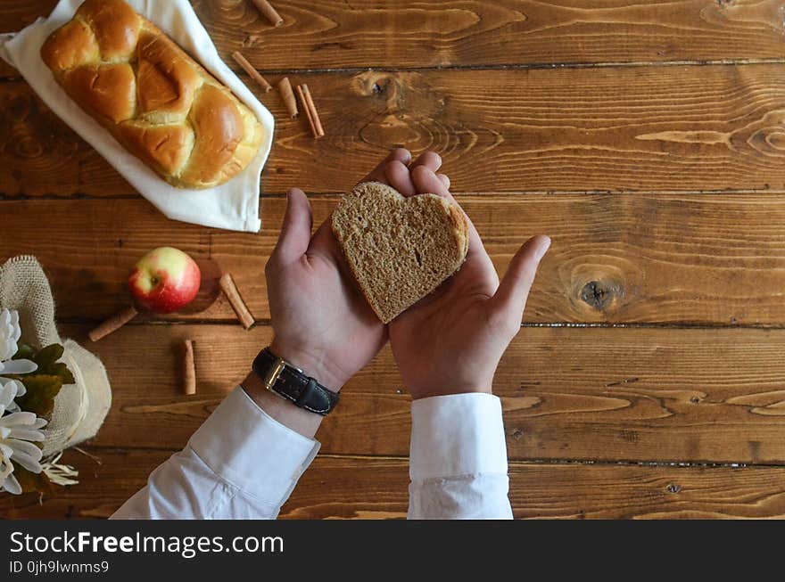 Person Holding Heart Shaped Bread