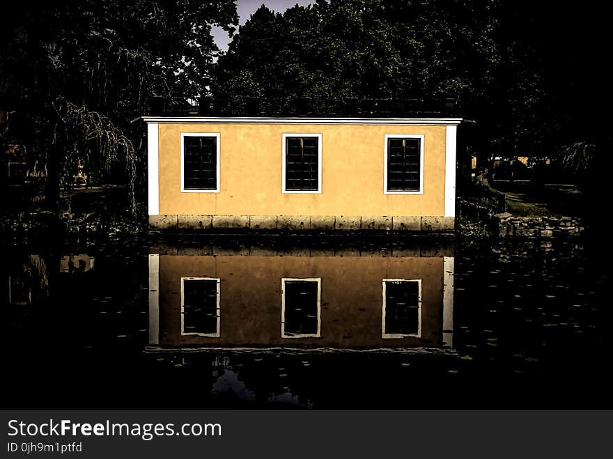 Beige and White House Beside Body of Water