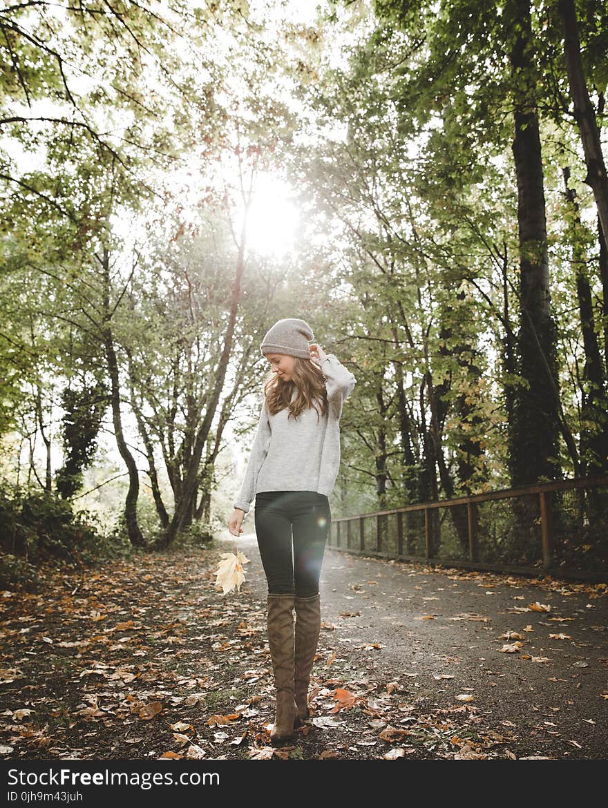 Woman in Gray Sweater Standing Between Forest Trees