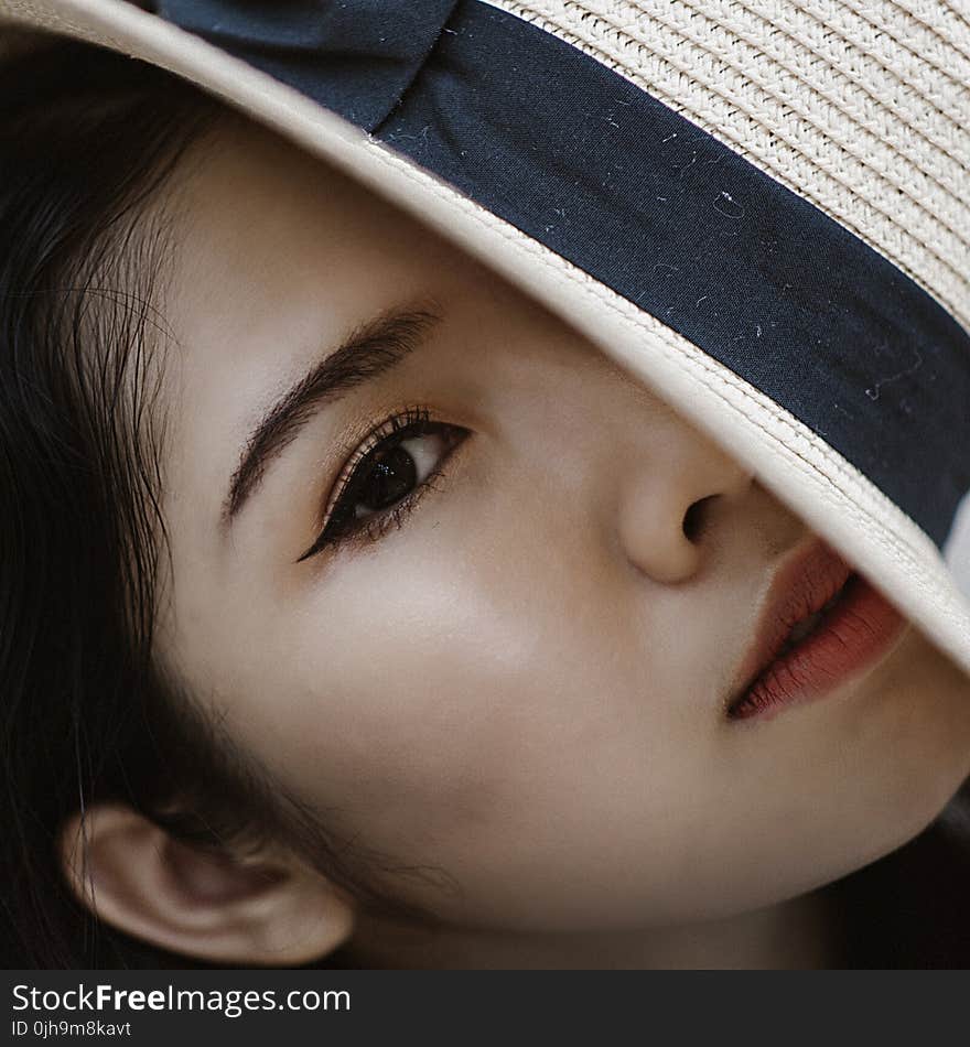 Woman Wearing Blue and Black Sun Gat