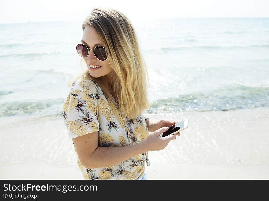 Woman Wearing Sunglasses At The Beach