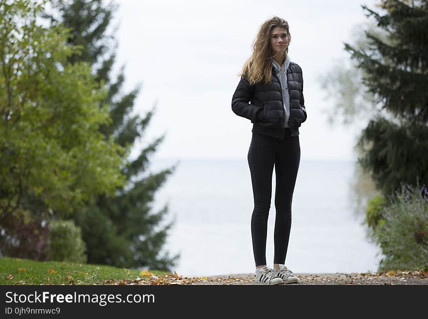 Woman in Black Winter Jacket Near Trees