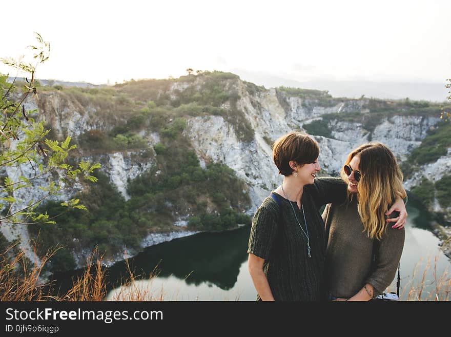 Two Woman Standing on a Cliff