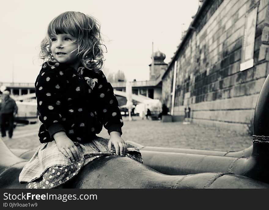 Grayscale Photo of Young Lady Sitting