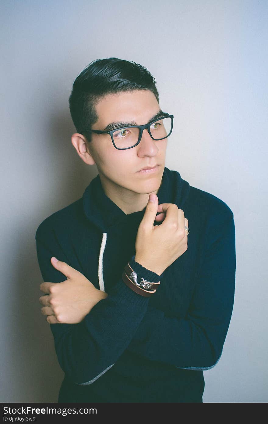 Man Wearing Eyeglasses Standing Near the Wall