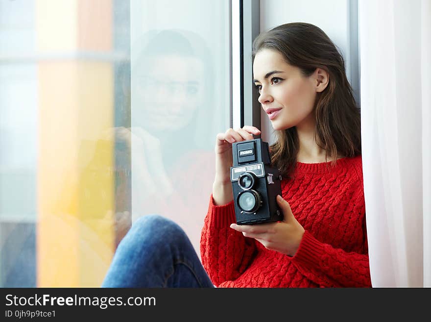 Woman Wearing Red Knitted Shirt Holding Instant Camera