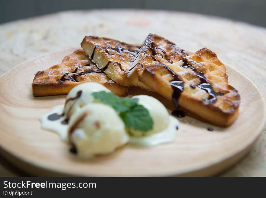 Shallow Focus Photography of Baked Bread With Chocolate Syrup Serve on Wooden Plate