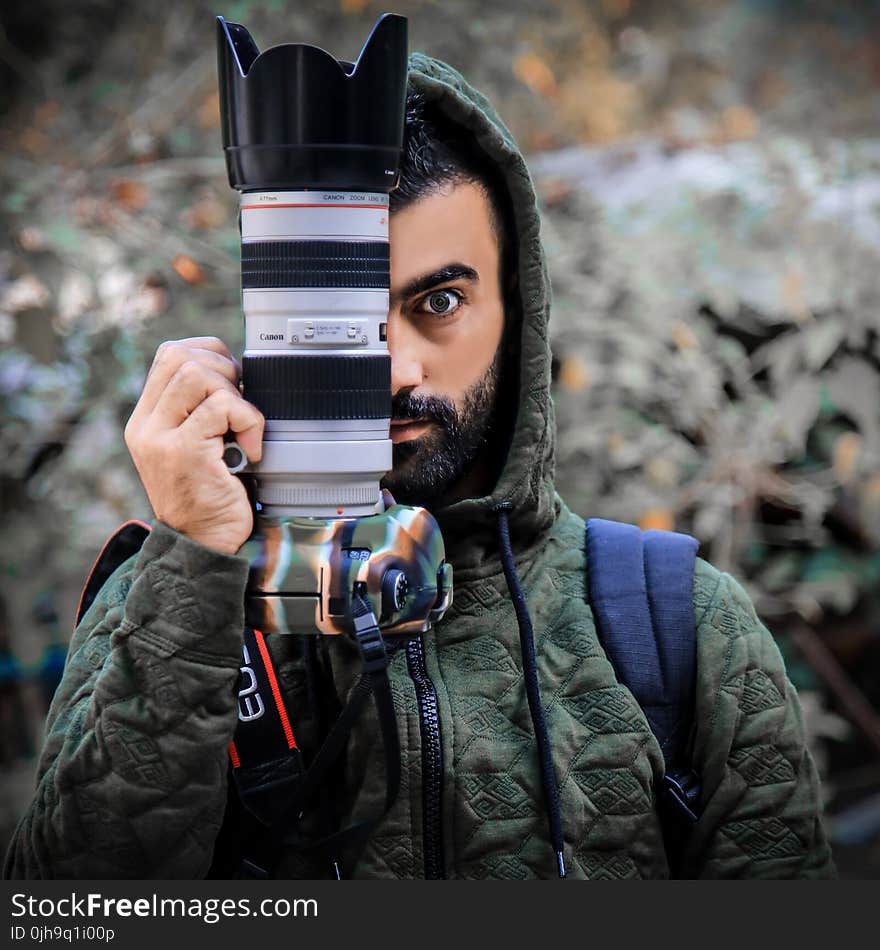 Person Holding a Dslr Camera