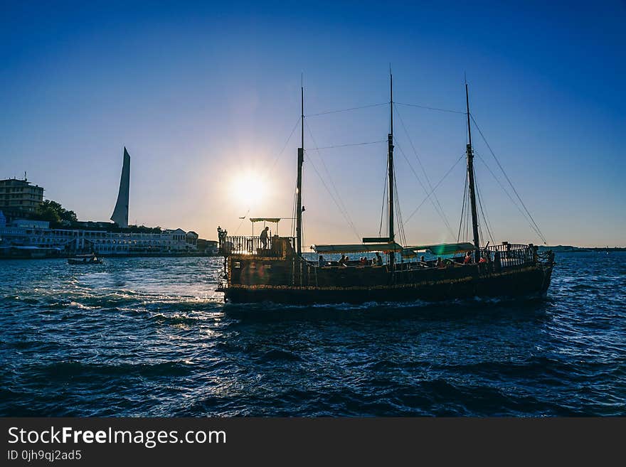 Green and Black Boat on Body of Water during Sunrise