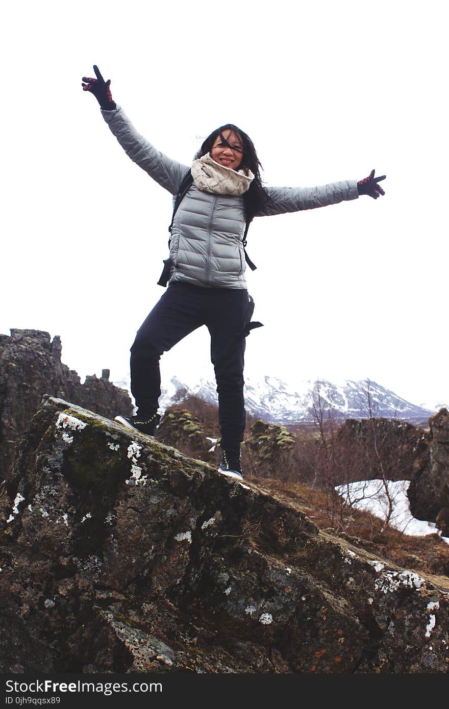 Woman Standing on a Rock Wearing Bubble Jacket