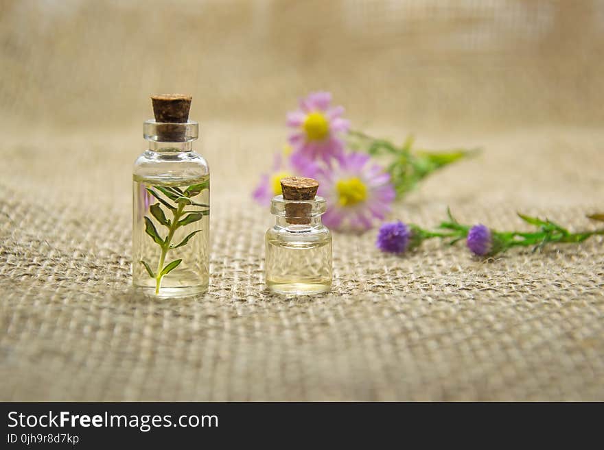 Two Clear Glass Bottles With Liquids