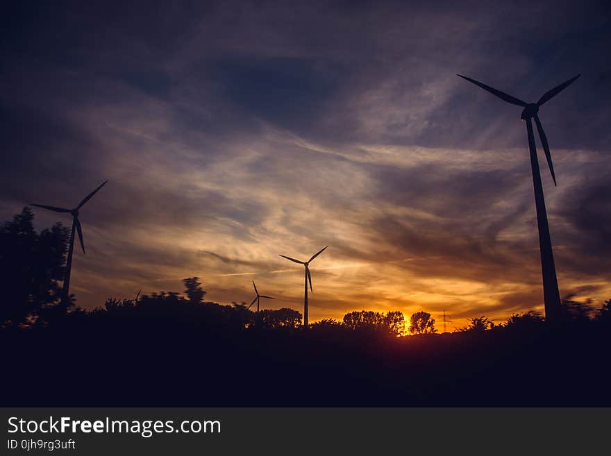 Black Windmills during Sunset