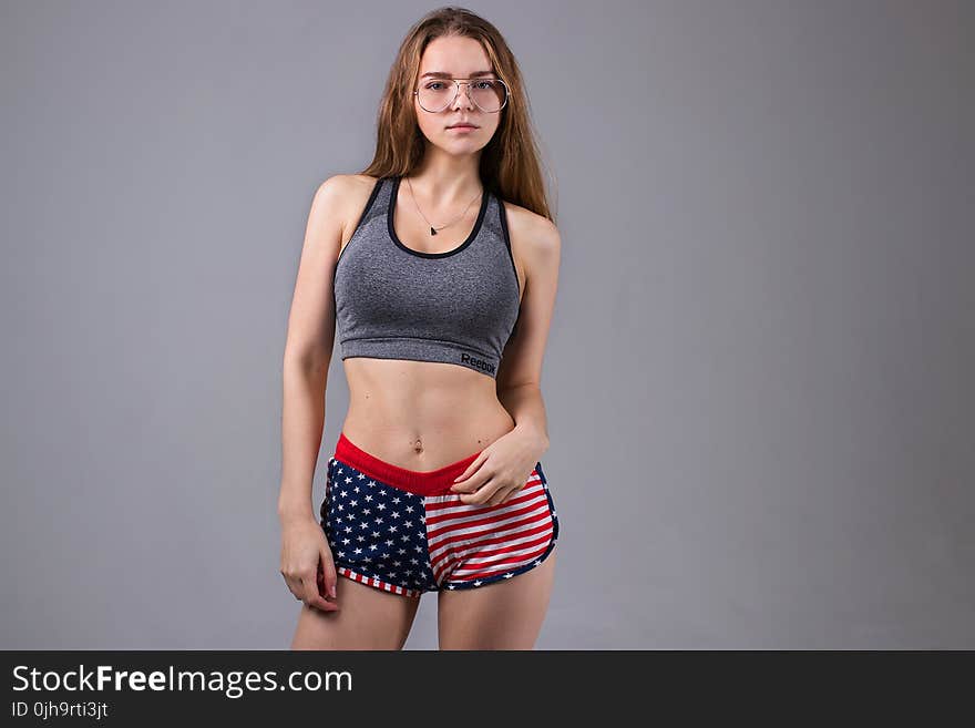 Woman Wearing Grey Sports Bra and U.s. Flag Printed Dolphin Shorts